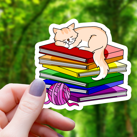 Cat Sleeping on top of Pride Books Sticker - 3"